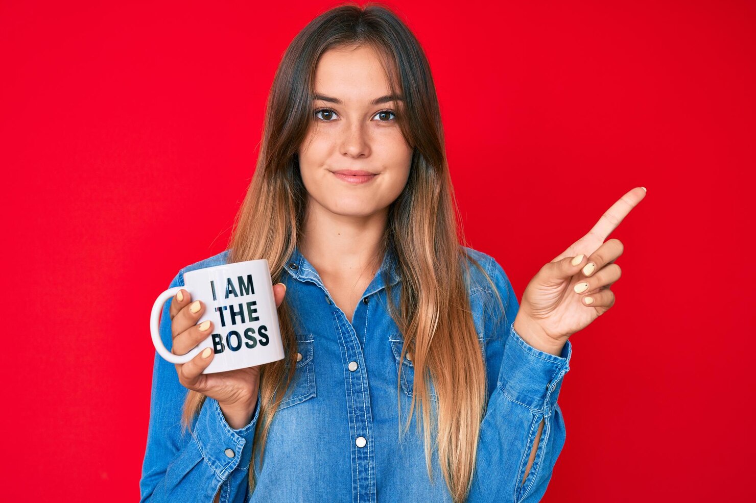 beautiful caucasian woman drinking from i am boss coffee cup smiling happy pointing with hand finger side 839833 26859